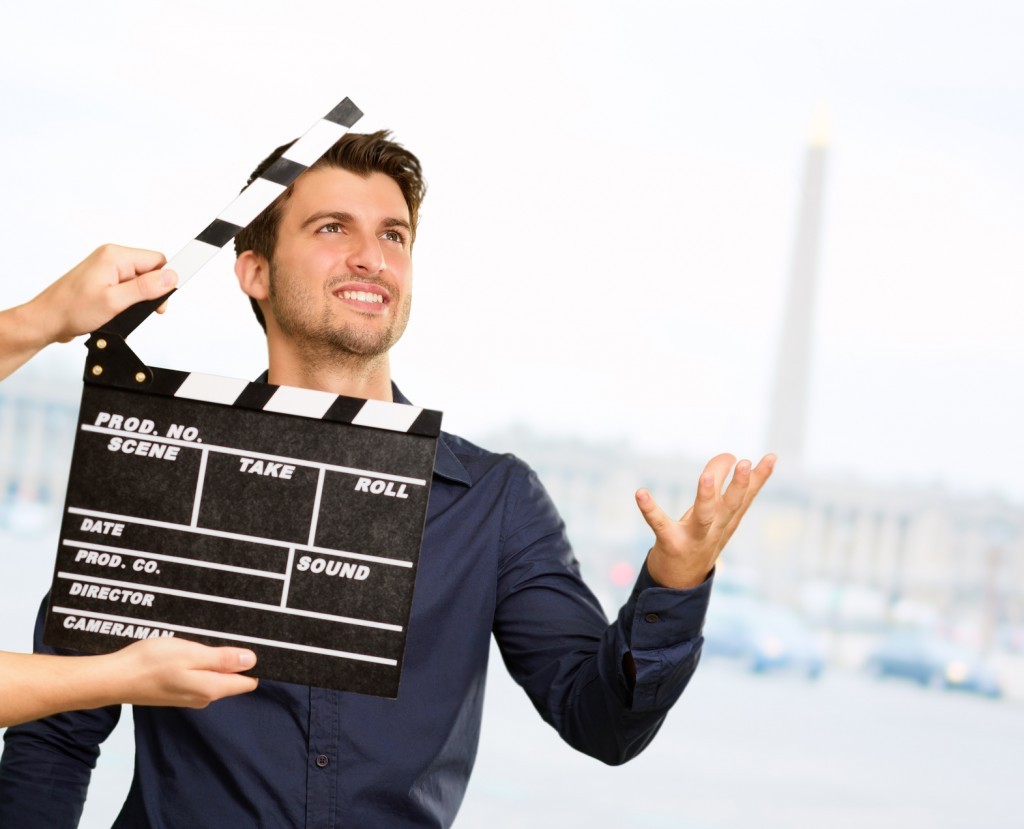 Film director clapping the clapper board.