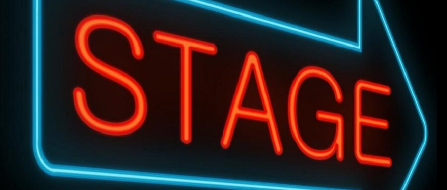 red stage sign in blue arrow on black background showing howto get to broadway auditions
