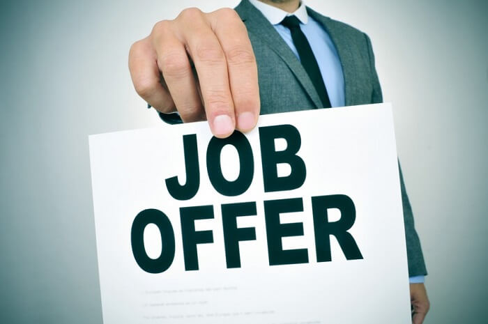Man holding sign with job offer